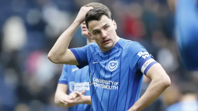 Portsmouth defender Regan Poole scratches his head