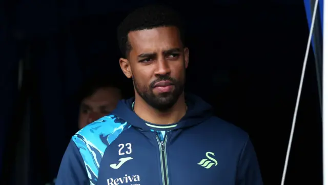 Cyrus Christie arrives at a Swansea game