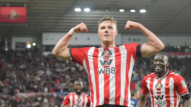 Dan Ballard flexes arms in celebration of a goal for Sunderland