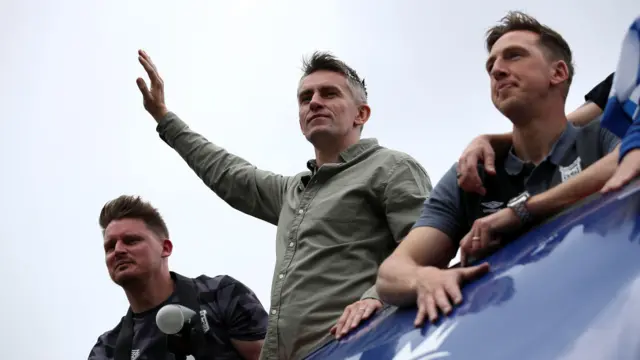 Ipswich manager Kieran McKenna waves from an open-top bus