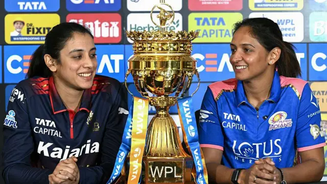 Smriti Mandhana of RCB and Harmanpreet Kaur of Mumbai Indians with the WPL trophy