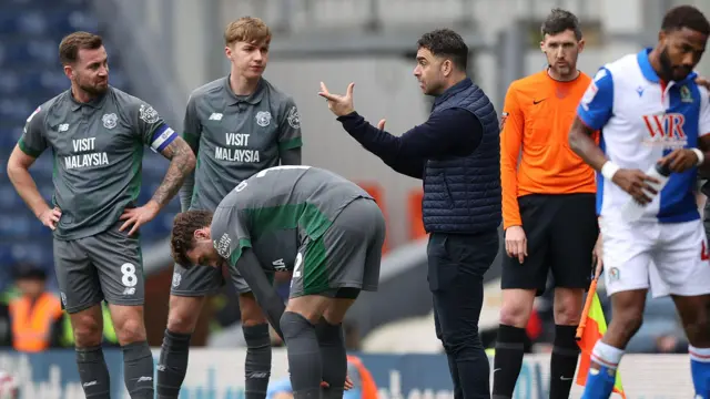 Cardiff City boss Omer Riza talks to his players
