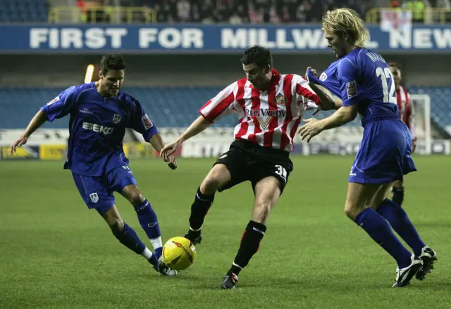 Michael Bridges of Sunderland is tackled by Darren Ward of Millwall during the Championship match between Millwall and Sunderland at The Den on November 5, 2004