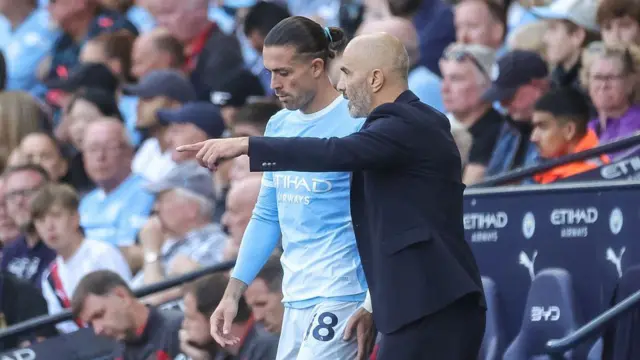 Enzo Maresca, manager of Manchester City, gives instructions to Jack Grealish