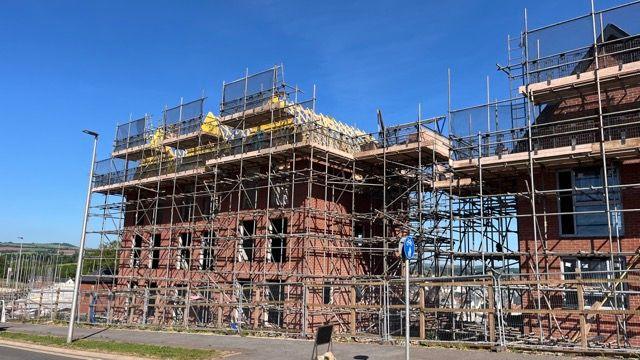 Scaffolding around new homes being constructed