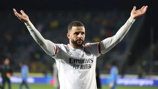 Kyle Walker celebrates with arms aloft while playing for AC Milan