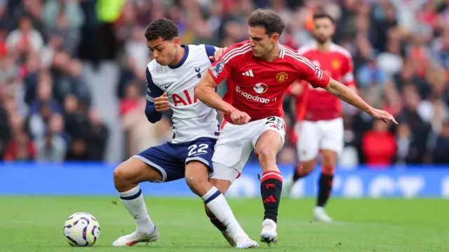 Brennan Johnson of Tottenham Hotspur battles for possession with Manuel Ugarte of Manchester United during the Premier League match between Manchester United FC and Tottenham Hotspur FC at Old Trafford