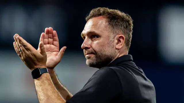 John Eustace applauding.