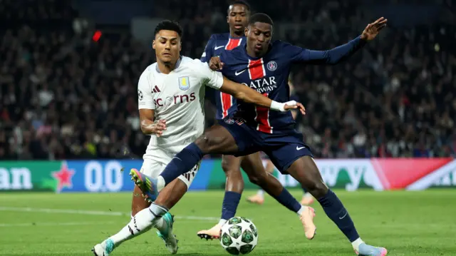 Ollie Watkins of Aston Villa battles with William Pacho of Paris Saint-Germain