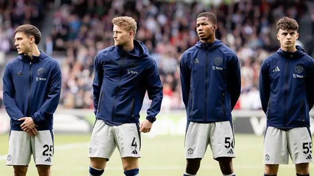 Manchester United players line up before a match