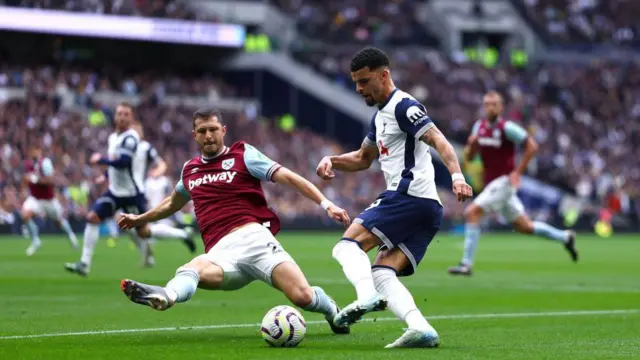 Dominic Solanke and Guido Rodriguez compete for the ball