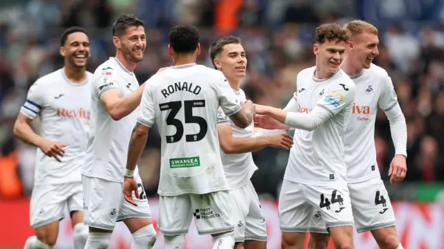 Swansea players including Thomas Woodward celebrate Leo Walta's goal against Charlton