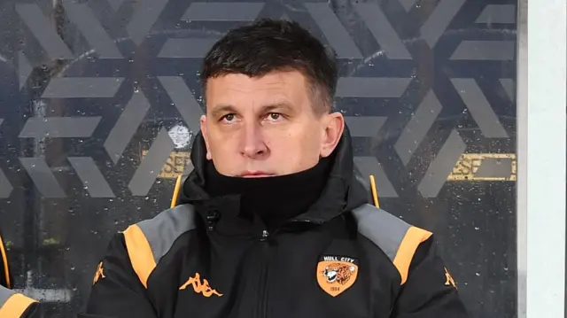 Sergej Jakirovic, wrapped up against the cold, sat on the bench ahead of Hulls' game with Blackburn 