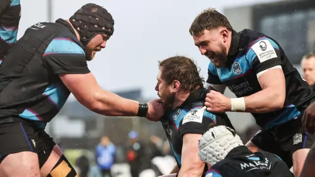 Glasgow players celebrate Patrick Schickerling's try in the win over Bulls