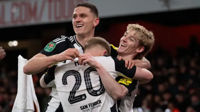 Anthony Gordon celebrates with Sven Botman and Lewis Hall
