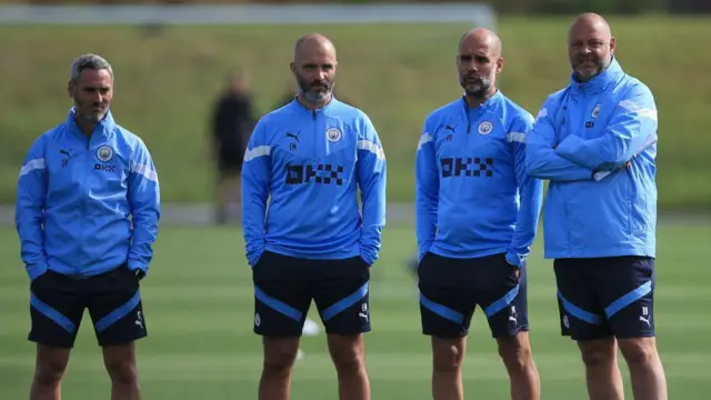 Manchester City's Spanish assistant manager Carlos Vicens, former assistant manager Enzo Maresca, Spanish manager Pep Guardiola and Spanish assistant manager Rodolfo Borrell attend a training session on September 13, 2022 at the Manchester City training ground