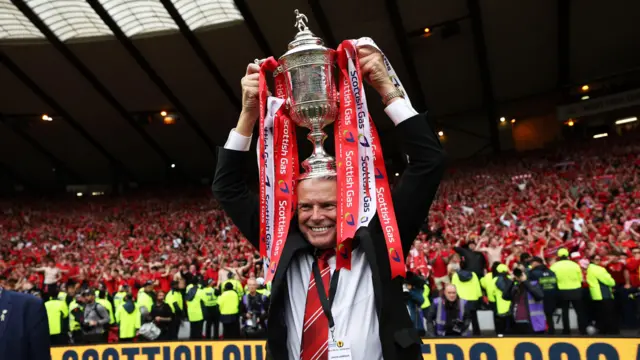 Dave Cormack with the Scottish Cup on his head
