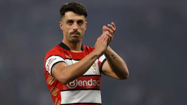 Adam Hastings applauds the Gloucester fans