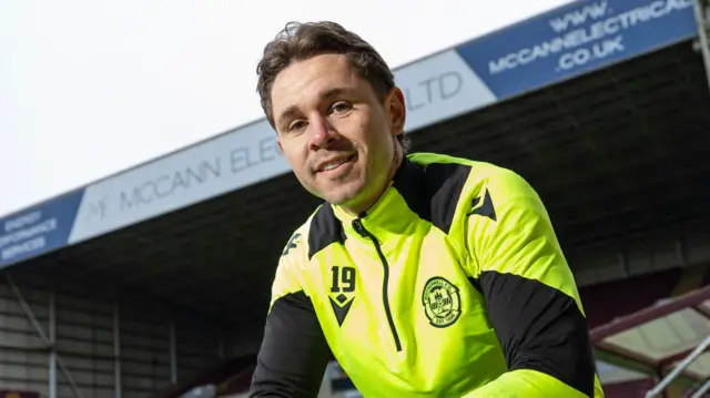 Sam Nicholson poses for photographers at Fir Park