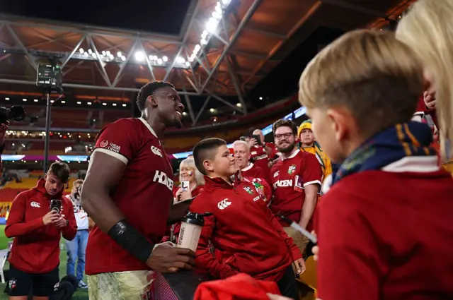 Maro Itoje of the British and Irish Lions takes a selfie fans after the team's victory in one of the series.