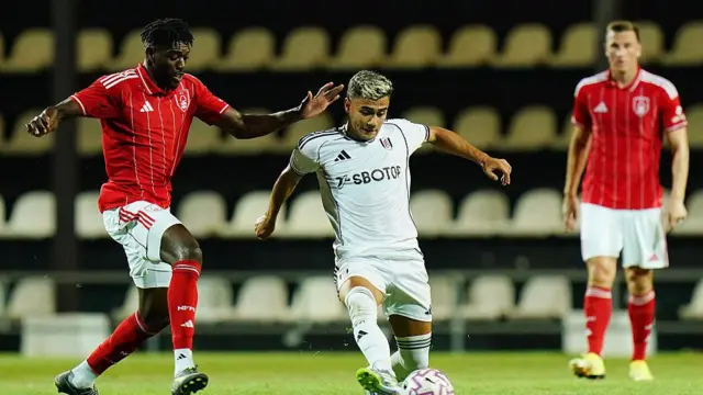 Andreas Pereira of Fulham with Ibrahim Sangare of Nottingham Forest