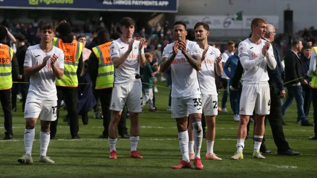 Swansea players applaud fans after their defeat at Millwall last weekend