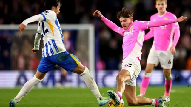 Tyler Dibling of Southampton challenges Kaoru Mitoma of Brighton & Hove Albion during the Premier League match between Brighton & Hove Albion FC and Southampton FC at Amex Stadium