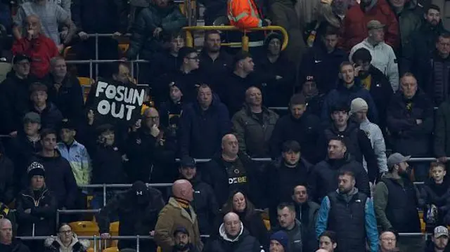 Wolves' fan with a sign saying 'Fosun out'