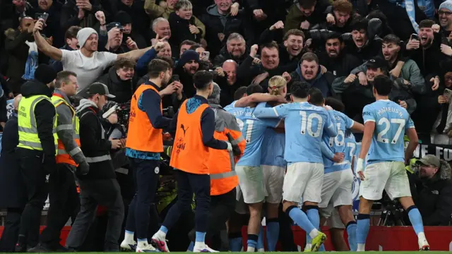 Manchester City's Erling Haaland celebrates with teammates and fans after scoring their second goal