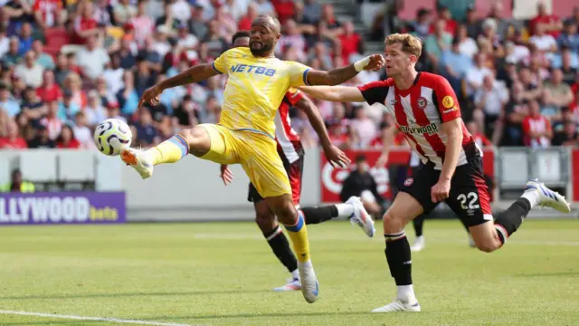 Jordan Ayew of Crystal Palace controls the ball under pressure from Nathan Collins of Brentford 