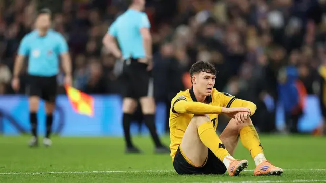 Jorgen Strand Larsen sits on the ground after a defeat