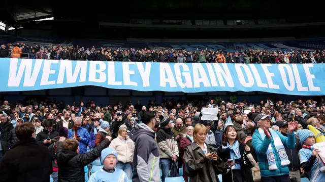 Manchester City fans display a banner reading 'Wembley again ole ole