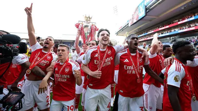 Arsenal celebrate with the Premier League trophy, as they are crowned the Champions of the Premier League.
