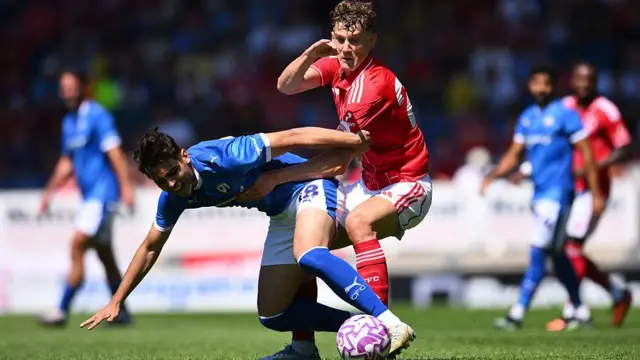 Miguel Freckleton of Chesterfield is challenged by Ryan Yates