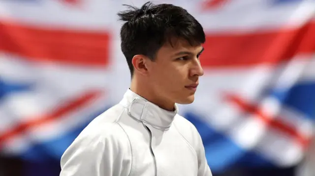 Joe Choong looks on during fencing