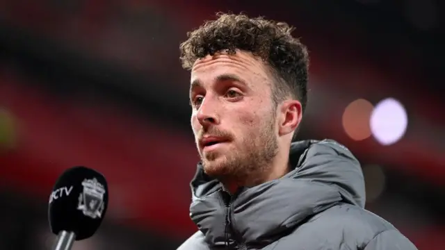 Diogo Jota speaks during a television interview