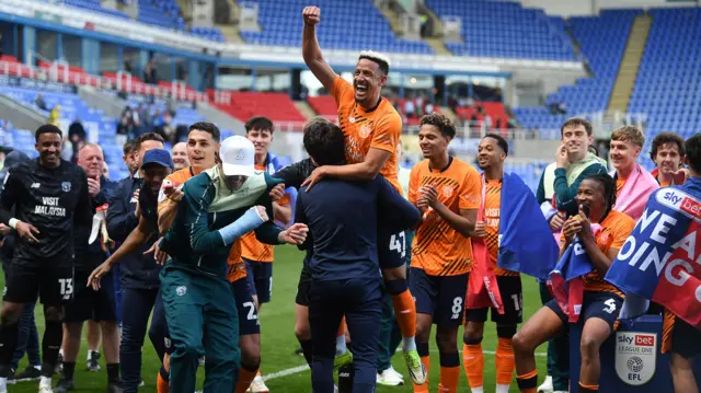 Manager Brian Barry-Murphy celebrates promotion with Cardiff City players