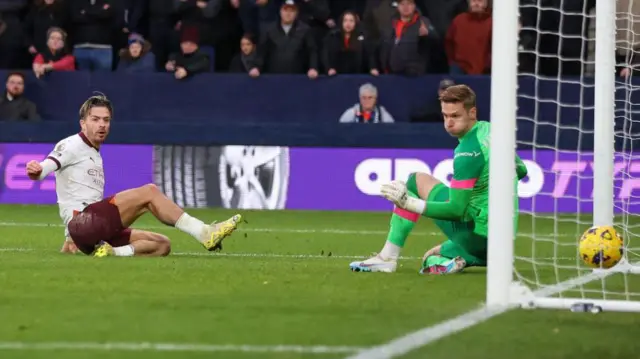 Jack Grealish of Manchester City scores the 2nd goal during the Premier League match between Luton Town and Manchester City at Kenilworth Road 