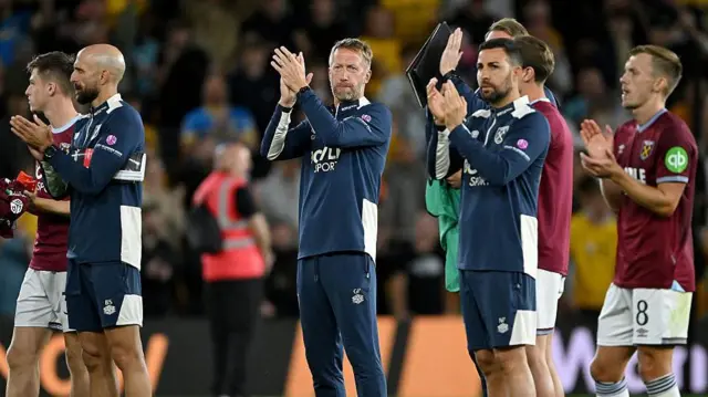 West Ham players and staff applaud fans at Wolves