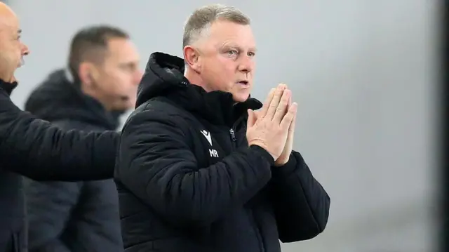 Mark Robins with hands clasped in prayer