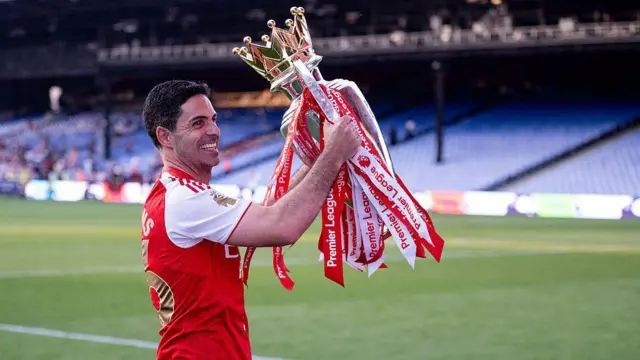  Mikel Arteta celebrates with the Premier League trophy