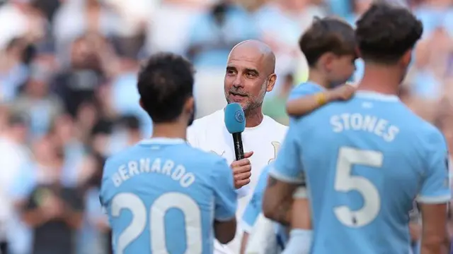 Pep' Guardiola, head coach of Manchester City, speaks to the fans inside the Etihad