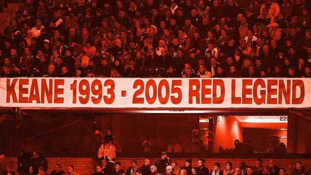 Manchester United fans sit around a banner that reads 'Keane 1993-2005 Red Legend'