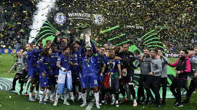 Chelsea players and staff lift Conference League trophy