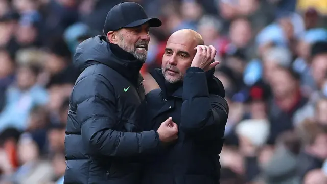 Pep Guardiola and Jurgen Klopp embracing on the touchline