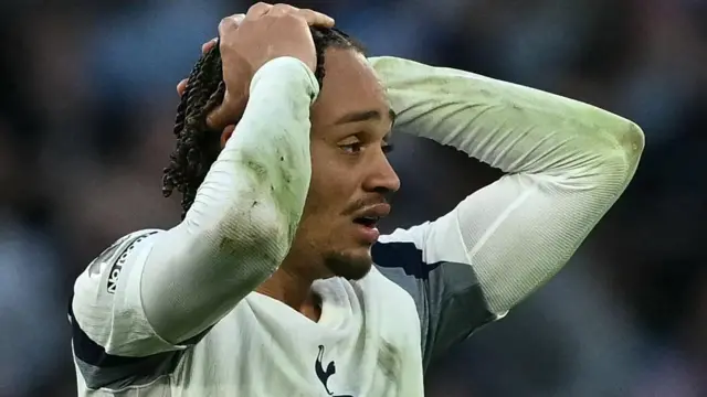 Xavi Simons holds his hands on his head 