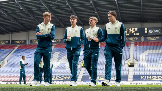 Rubin Colwill, Joel Colwill, Isaak Davies and Joel Bagan of Cardiff City onn the pitch before an away game this season 