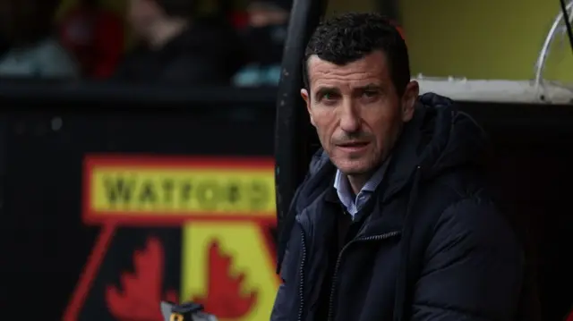 Javi Gracia sitting on the bench at Watford's stadium Vicrage Road. 