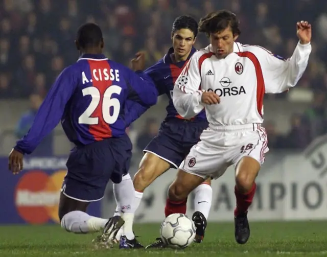 Mikel Arteta battles with Andrea Pirlo during PSG v AC Milan