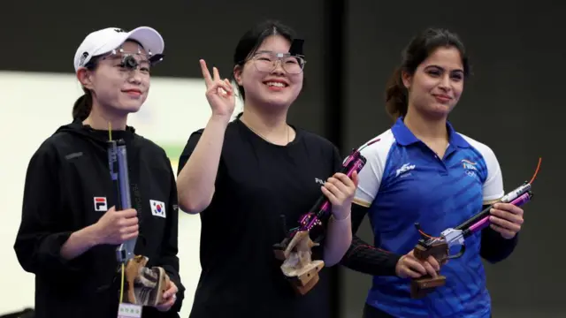 South Korea's Kim Yeji, gold medallist South Korea's Oh Ye Jin and bronze medallist, India's Manu Bhaker at the end of the 10m air pistol women's final during the 2024 Paris Olympic Games